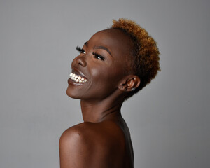 Close up head and shoulders portrait of a pretty young African woman with natural hair. variety of emotive  facial expressions. Isolated on a light grey studio background.