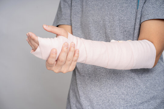 Asian people broken arms from sports accidents. In the studio, injury.