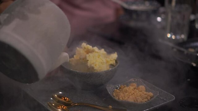 Hands of cook making ice cream with liquid nitrogen, Cook mix homemade icecream with dry ice