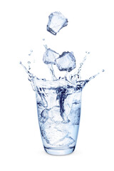 Ice cubes falling into glass toned blue isolated on white background. Splash in glass of cool water with ice.