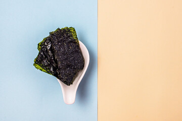 Crispy Dried Seaweed Japanese Snack Blue and Yellow Background Copy Space