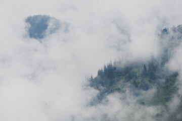 Naklejka na ściany i meble Mountain view in fog or clouds