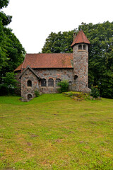 Fototapeta na wymiar Built in 1925 from field stone, the Neo-Romanesque Evangelical-Ausburg church in Rasząg na warmi in Poland.