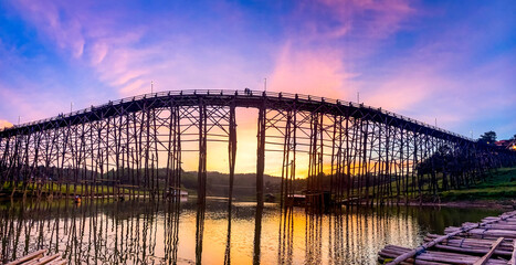 Fototapeta premium Mon Bridge, old wooden bridge at sunset in Sangkhlaburi, Kanchanaburi, Thailand