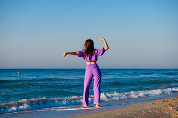 Girl dance at beach with bluetooth speaker