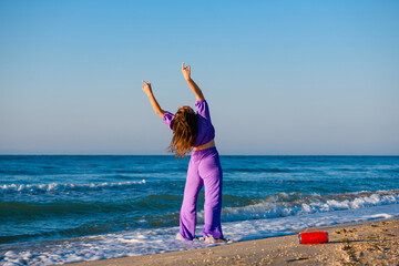 Girl exercise with music at sea beach