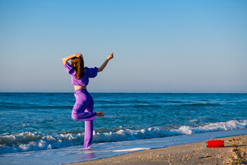 Girl dance at beach with bluetooth speaker