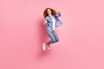 Full length photo of charming funky lady dressed jeans shirt jumping showing thumbs up smiling...
