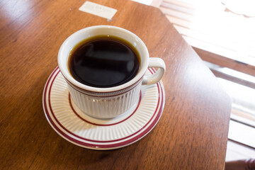 Cup of coffee on a wooden table.