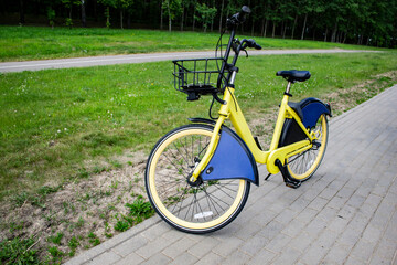 Fototapeta premium Electric bike for rent is parked in the city, in the park - photo. Wheel Fender with empty place for ad text.