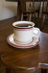 Cup of coffee on a wooden table.