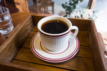 Cup of coffee on a wooden table.