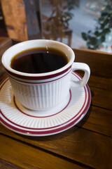 Cup of coffee on a wooden table.