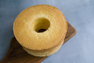 Chiffon cake on a wood cutting board.