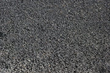 Asphalt - photo texture, background. Stone granulated surface for texturing. Rough, dark bitumen...