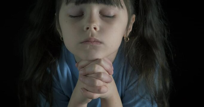 Child believe and pray. A little girl hope and believe in God and try to ask for help.