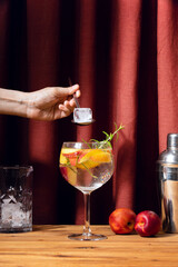 Peach and rosemary Gin Tonic summer cocktail in a glass