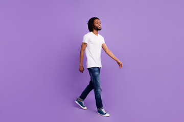 Full length body size view of attractive cheerful guy walking free time isolated over bright violet purple color background