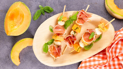 melon salad with prosciutto ham and mozzarella - obrazy, fototapety, plakaty