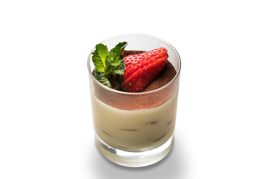 Tiramisu dessert in glass with strawberry slices and mint leaves, singol serving size isolated on white, copy space