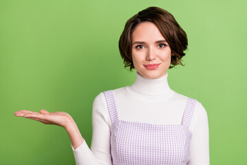 Photo portrait woman keeping blank space on hand isolated pastel green color background