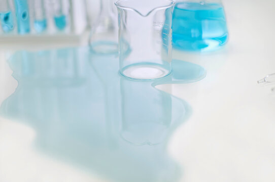 Spilled liquid and glassware on table in laboratory