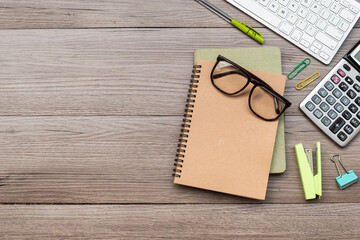 Top view of business desk with notepad keyboard and pen, eye glasses,Staples,pen Copy space.above shot