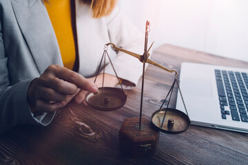 Justice and law concept.Male judge in a courtroom with the gavel, working with, computer and...