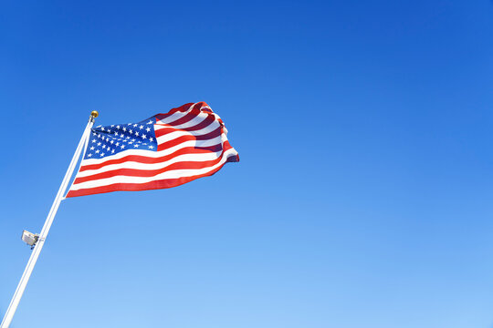 American flag waving during sunny day