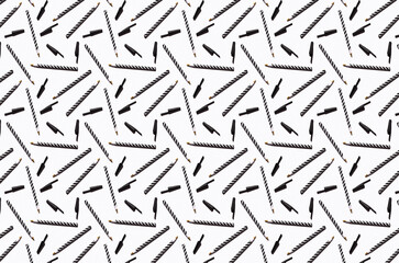 Pattern of black and white striped pens flat laid against white background