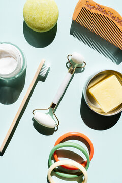Studio shot of wooden comb, bamboo toothbrush, colorful bracelets, organic soap, shampoo and other eco-friendly self-care products