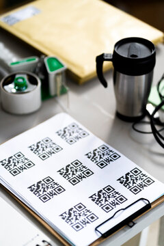 QR codes by coffee pot on desk at office