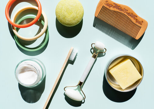 Studio shot of wooden comb, bamboo toothbrush, colorful bracelets, organic soap, shampoo and other eco-friendly self-care products