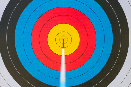 Archery target with arrow in bull's eye