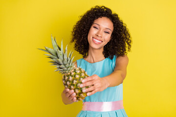 Photo of pretty young afro american nice woman give pineapple fruit you isolated on yellow color background