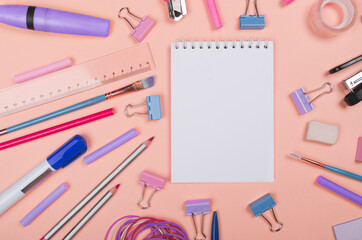 Different school supplies on light yellow background