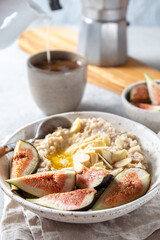 Healthy Oatmeal with figs. Coffee, oatmeal breakfast concept