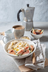 Healthy Oatmeal with figs. Coffee, oatmeal breakfast concept