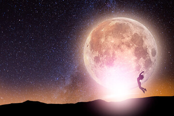 Fototapeta na wymiar Fantasy landscape. The full moonrise over the hill. The girl silhouette jumping on the full moon on the starry background