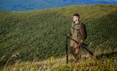Hunter with hunting gun and hunting form to hunt. Hunter is aiming. The man is on the hunt. Hunt...