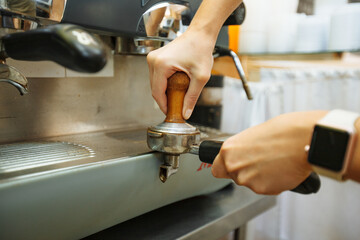 the barista makes coffee