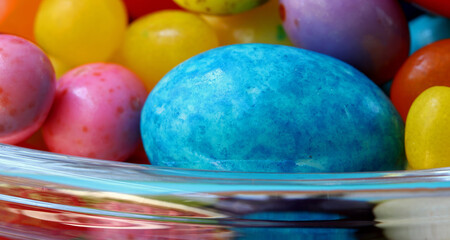 colorful easter eggs and candies in glass bowl