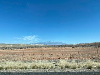 Desert mountain landscape with highway fence