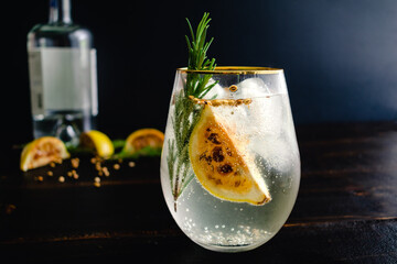 Charred Lemon, Rosemary and Coriander Gin and Tonics: Gin and tonic cocktails garnished with charred lemon wedges and aromatics