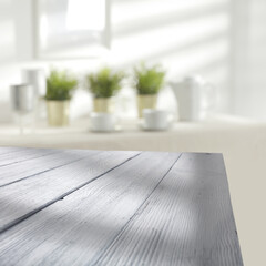 Wooden desk with shadows and home interior with window 