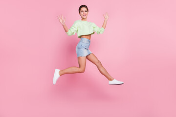 Fototapeta na wymiar Full body profile side photo of young girl happy positive smile jump up wave hello isolated over pastel color background