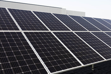 solar panels on ground infront of industrial building renewable energy
