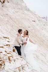 Beautiful wedding couple bride and groom at wedding day outdoors at ocean beach. Happy marriage couple o