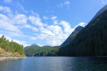 A beautiful scenic view of the harmony islands, in hotham sounds, sunshine coast, canada.  Pretty calm ocean water, forests and mountains on a beautiful sunny day