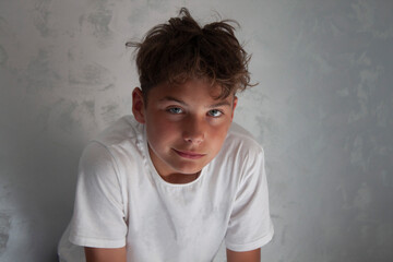the boy looks at the camera with contempt